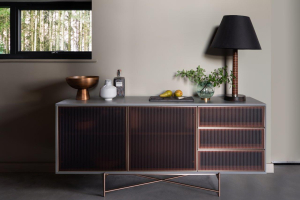 fluted glass sideboard with lamp against wall