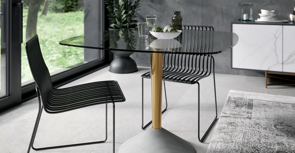 Iona Large Clear Square Glass Dining Table with Brass Pedestal & Concrete Base Ft. Finn Black Dining Chairs © GillmoreSPACE Ltd